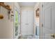 Bright hallway featuring a door to the exterior, laundry room and a separate closet at 705 Normandy Rd, Mooresville, NC 28117