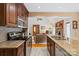 Open kitchen featuring granite countertops, stainless steel appliances, and seamless flow to living area at 705 Normandy Rd, Mooresville, NC 28117
