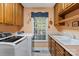 Functional laundry room with sink, window, and ample cabinet storage and a view to the deck at 705 Normandy Rd, Mooresville, NC 28117