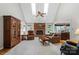 Cozy living room featuring vaulted ceilings, a brick fireplace, and ample natural light at 705 Normandy Rd, Mooresville, NC 28117