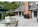 Enjoy outdoor dining on the deck with an umbrella table and a grill with an attached brick chimney at 705 Normandy Rd, Mooresville, NC 28117