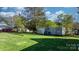 Expansive backyard with storage sheds and carport, offering ample outdoor space at 71 14Th Se St, Hickory, NC 28602