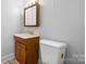 Bathroom features a vanity with wood cabinet, medicine cabinet and toilet at 71 14Th Se St, Hickory, NC 28602