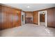 Bedroom featuring carpet, wood paneling, built-in storage, and detailed wood fireplace at 71 14Th Se St, Hickory, NC 28602