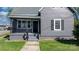 Charming home featuring a covered front porch with classic black railing and gray painted steps at 71 14Th Se St, Hickory, NC 28602