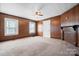 Inviting living room featuring wood paneling, carpet, brick fireplace, and bright windows at 71 14Th Se St, Hickory, NC 28602