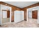 Living room offers an open floor plan with view to kitchen, with wood paneled walls at 71 14Th Se St, Hickory, NC 28602