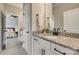 Bathroom with granite counters, white cabinets, and a view of the bedroom with a ceiling fan at 7157 Sumters Camp Trl, Indian Land, SC 29707