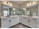 Bathroom featuring double sinks, dark marble floors and large mirrors above the counter at 7157 Sumters Camp Trl, Indian Land, SC 29707