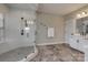 Bathroom featuring a glass shower with a rainfall shower head and white marble floors at 7157 Sumters Camp Trl, Indian Land, SC 29707