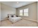 Comfortable bedroom with a queen bed, soft carpet, and a large window at 7157 Sumters Camp Trl, Indian Land, SC 29707