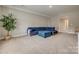 Well-lit bonus room showcases a blue sectional sofa, a plant, and a simple yet elegant ottoman at 7157 Sumters Camp Trl, Indian Land, SC 29707