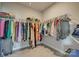 Walk-in closet with an expansive clothing rack holding a diverse collection of garments and accessories at 7157 Sumters Camp Trl, Indian Land, SC 29707