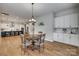 Cozy breakfast nook with a view into a modern kitchen featuring stainless appliances and a large island at 7157 Sumters Camp Trl, Indian Land, SC 29707