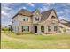Beautiful two story home with stone and siding details and a well manicured lawn at 7157 Sumters Camp Trl, Indian Land, SC 29707
