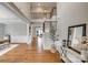 Bright foyer with hardwood floors, elegant wainscoting, and a staircase leading to the upper level at 7157 Sumters Camp Trl, Indian Land, SC 29707