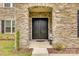 Close-up of a solid double front door framed by stone, creating an inviting and secure entrance at 7157 Sumters Camp Trl, Indian Land, SC 29707