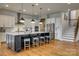 Modern kitchen featuring a large island, white cabinetry, stainless steel appliances, and hardwood flooring at 7157 Sumters Camp Trl, Indian Land, SC 29707