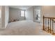 Large carpeted loft area with a staircase and a view into the side room at 7157 Sumters Camp Trl, Indian Land, SC 29707
