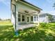 Back porch with ceiling fan and ample light offering outdoor living space at 7185 Chamberlain Dr, Harrisburg, NC 28075