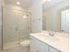 The bathroom has a clear glass shower, marble-style wall tiles, white cabinets, and brushed metal finishes at 7185 Chamberlain Dr, Harrisburg, NC 28075