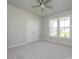 This bedroom features carpet floors, a ceiling fan, double-door closet, and natural light from the windows at 7185 Chamberlain Dr, Harrisburg, NC 28075