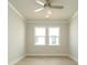 Bright bedroom with two windows, ceiling fan, and light wood-look flooring at 7185 Chamberlain Dr, Harrisburg, NC 28075