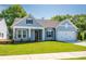 Charming one-story home with blue siding, well-manicured lawn, and attached two-car garage at 7185 Chamberlain Dr, Harrisburg, NC 28075