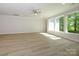 Open-concept living space featuring large windows overlooking a serene outdoor view at 7185 Chamberlain Dr, Harrisburg, NC 28075