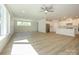 Open-concept living space with a modern kitchen and ample natural light from large windows at 7185 Chamberlain Dr, Harrisburg, NC 28075