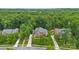 Stunning aerial view of home with brick facade, mature trees, and professionally landscaped yard at 7302 Yellowhorn Trl, Waxhaw, NC 28173