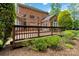 View of a deck with a black metal railing surrounded by lush greenery at 7302 Yellowhorn Trl, Waxhaw, NC 28173