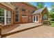 Exterior view of a brick home with a large deck and French doors at 7302 Yellowhorn Trl, Waxhaw, NC 28173
