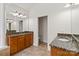 Bathroom with granite countertops, wood cabinets, and tile floor at 7302 Yellowhorn Trl, Waxhaw, NC 28173