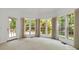 Bedroom featuring neutral walls, carpeted floors, and windows overlooking a landscaped yard at 7302 Yellowhorn Trl, Waxhaw, NC 28173