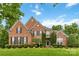 Charming brick home with a well-maintained lawn and manicured landscaping, including trimmed bushes at 7302 Yellowhorn Trl, Waxhaw, NC 28173