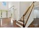 Elegant foyer with hardwood floors, a staircase, and a view into the living area, filled with natural light at 7302 Yellowhorn Trl, Waxhaw, NC 28173