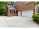 Spacious three-car garage with a wide concrete driveway and brick siding, offering ample parking at 7302 Yellowhorn Trl, Waxhaw, NC 28173