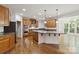 Bright kitchen featuring granite countertops, stainless steel appliances, and hardwood floors at 7302 Yellowhorn Trl, Waxhaw, NC 28173