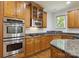Modern kitchen with stainless steel appliances, granite countertops, and wood cabinets at 7302 Yellowhorn Trl, Waxhaw, NC 28173