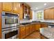 Close up of a kitchen featuring wooden cabinets, stainless steel appliances, and granite countertops at 7302 Yellowhorn Trl, Waxhaw, NC 28173