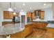 Large kitchen featuring granite countertops and wooden cabinets at 7302 Yellowhorn Trl, Waxhaw, NC 28173