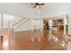 Open-concept living room with hardwood floors, a staircase, and a view into the kitchen, perfect for entertaining at 7302 Yellowhorn Trl, Waxhaw, NC 28173