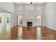 Bright living room with large windows, fireplace, and hardwood floors at 7302 Yellowhorn Trl, Waxhaw, NC 28173