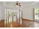 Spacious living room featuring hardwood floors, high ceilings, and plenty of natural light at 7302 Yellowhorn Trl, Waxhaw, NC 28173