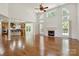Open-concept living room with hardwood floors and fireplace at 7302 Yellowhorn Trl, Waxhaw, NC 28173