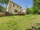 Expansive backyard featuring a wooden deck, lush lawn and a charming split rail fence at 7409 Tarland Ln, Charlotte, NC 28269