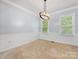 Elegant dining room with chair rail molding, neutral carpet, and chandelier fixture at 7409 Tarland Ln, Charlotte, NC 28269