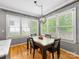 Dining room featuring natural lighting, hardwood floors, and a view to the backyard at 7409 Tarland Ln, Charlotte, NC 28269