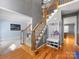Spacious foyer features staircase with decorative iron railing and access to multiple rooms at 7409 Tarland Ln, Charlotte, NC 28269
